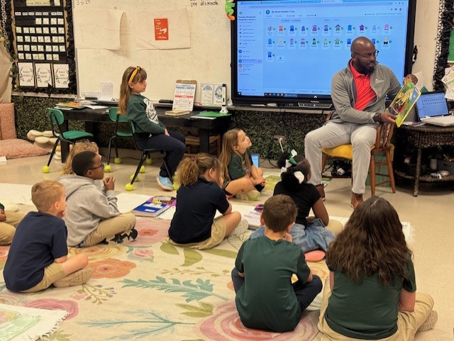 Impact Team Chair Jermaine Davis Reading at Peabody Montessori in 2024